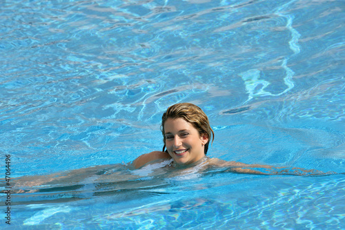 Smiling woman swimming