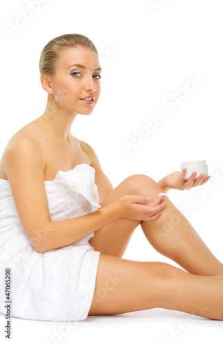 Young healthy girl applying body cream
