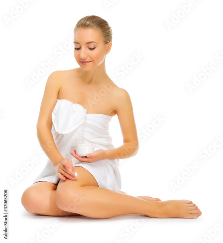 Young healthy girl applying body cream