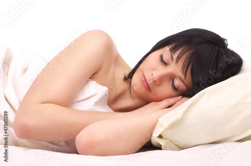 Beautiful young woman sleeping in the bed