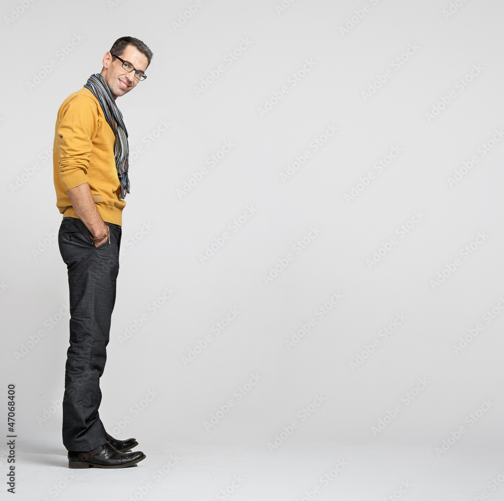 Handsome man casually leaning against the wall Handsome man casually leaning against the wall