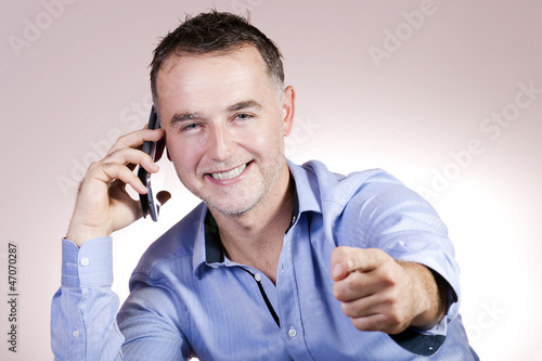 Happily talking on the phone of the businessman.
