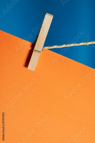 Sheet of paper with space for copy text, hanging from a rope wit