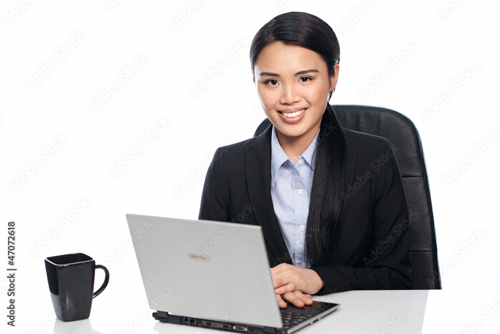 Successful Asian businesswoman at her desk Successful Asian businesswoman at her desk