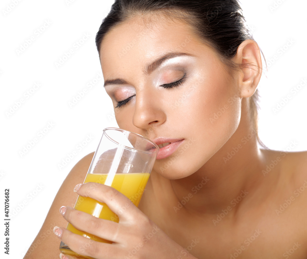 A young woman drinking orange juice A young woman drinking orange juice