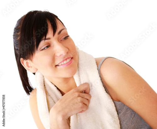 A smiling woman with a towel  isolated on white