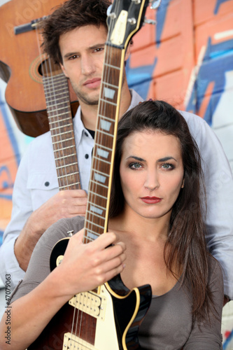 young woman and man playing in a music band