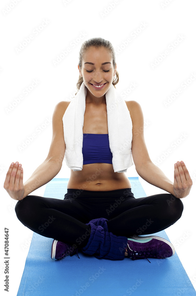 Attractive brunette meditating in lotus posture Attractive brunette meditating in lotus posture