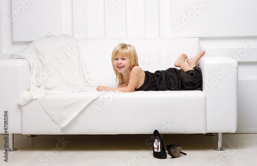 girl lying on a white sofa in my mother's dress,