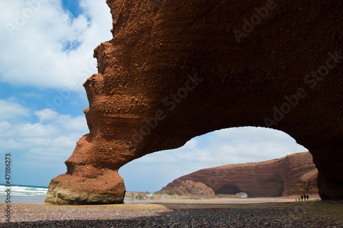 huge red cliffs with arch on the beach Legzira. Morocco