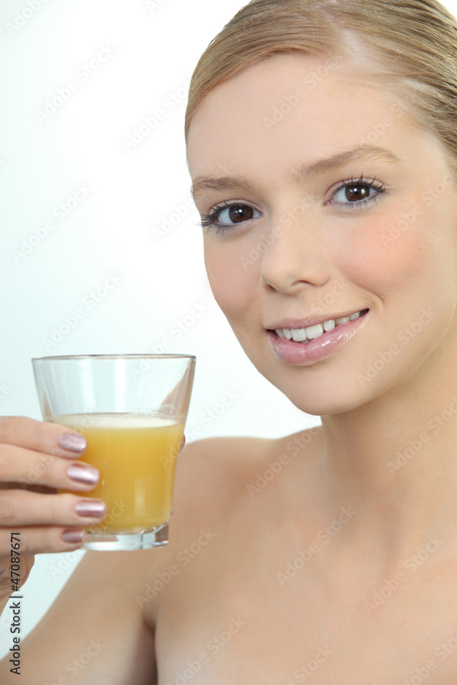 Woman drinking a glass of orange juice Woman drinking a glass of orange juice