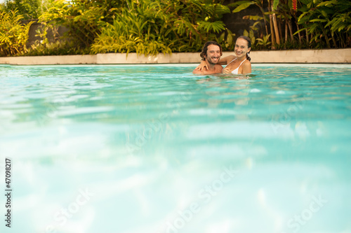the couple bathes and swims in the pool at the hotel © Михаил Решетников