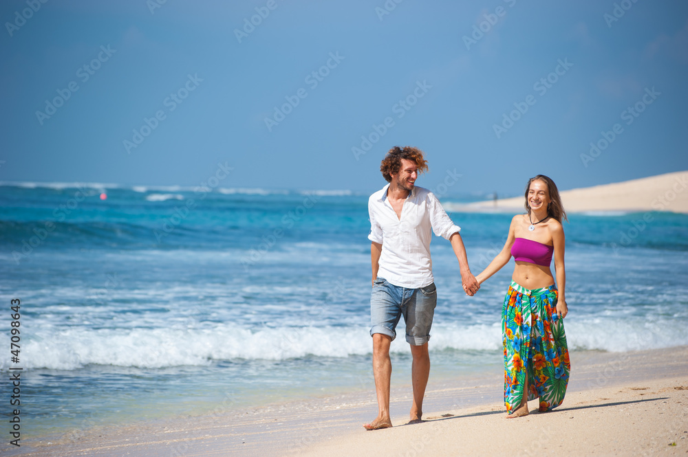 loving couple resting on the beach in the sand on the island of Bali. loving couple resting on the beach in the sand on the island of Bali.