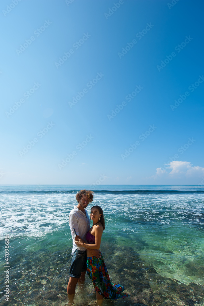 loving couple resting on the beach in the sand on the island of Bali.