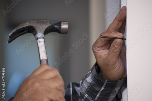 dribing the nail with hammer