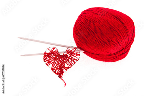 Knitting yarn with needles and a heart