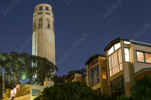 Coit Tower and houses at night in San Francisco, California