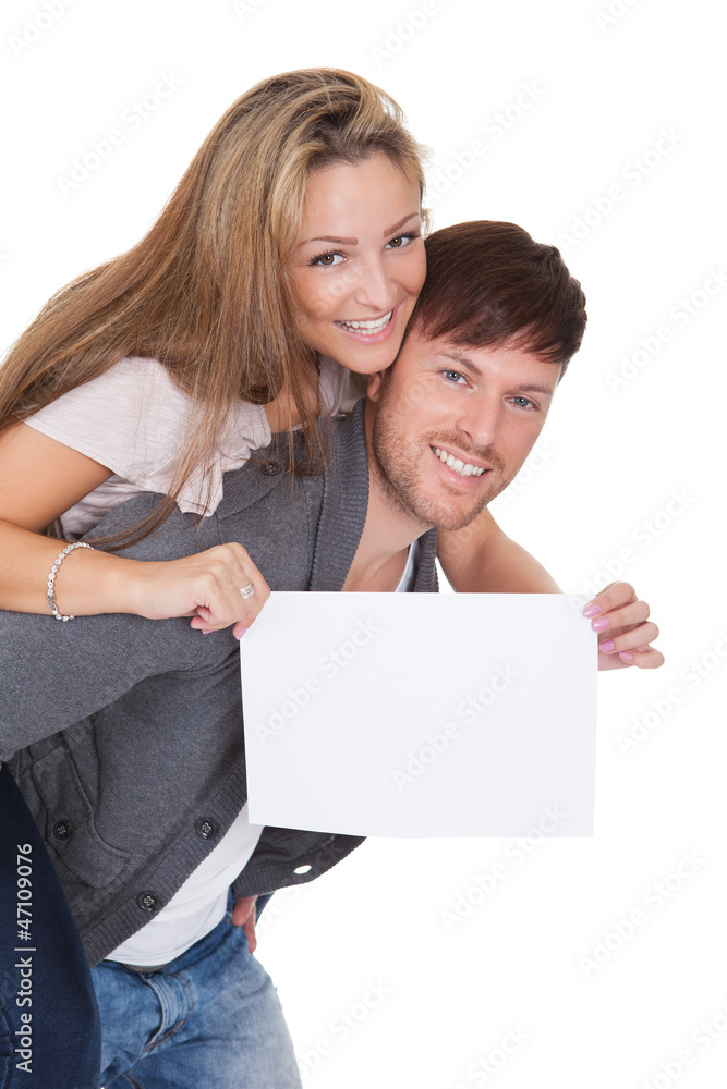 Woman getting a piggyback ride with blank sign Woman getting a piggyback ride with blank sign