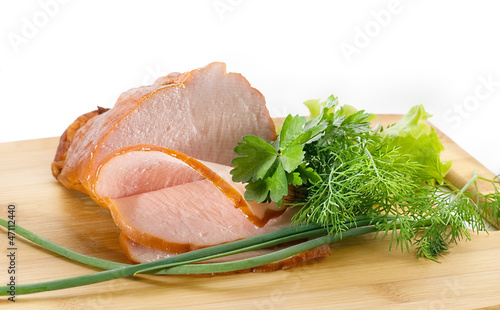 Thinly sliced ham on a cutting board
