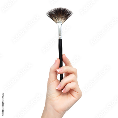 isolated female hand with brush for makeup