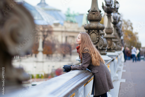 Photography Romantic young woman with beautiful long hair on a bridge in Par