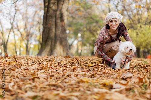 Young woman with a dogn the autumn forest photo