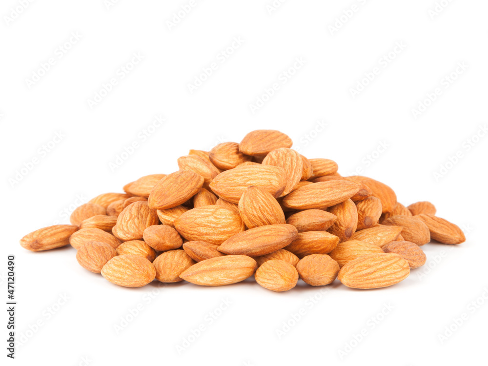 A pile of dried almonds isolated on white background A pile of dried almonds isolated on white background