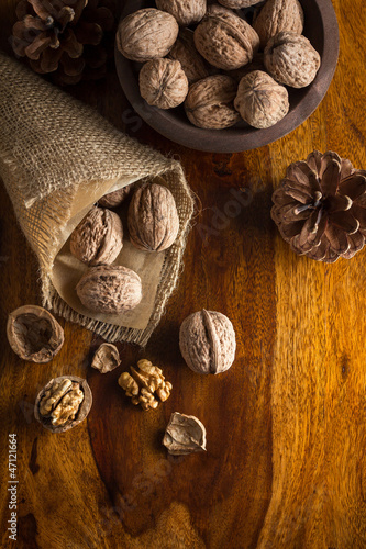 Autumn still life with walnuts on wooden table