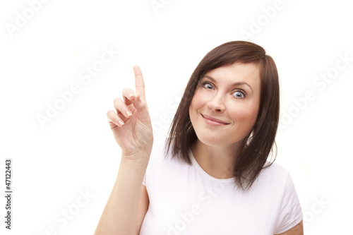 Young woman with crazy smile and rised finger shows up