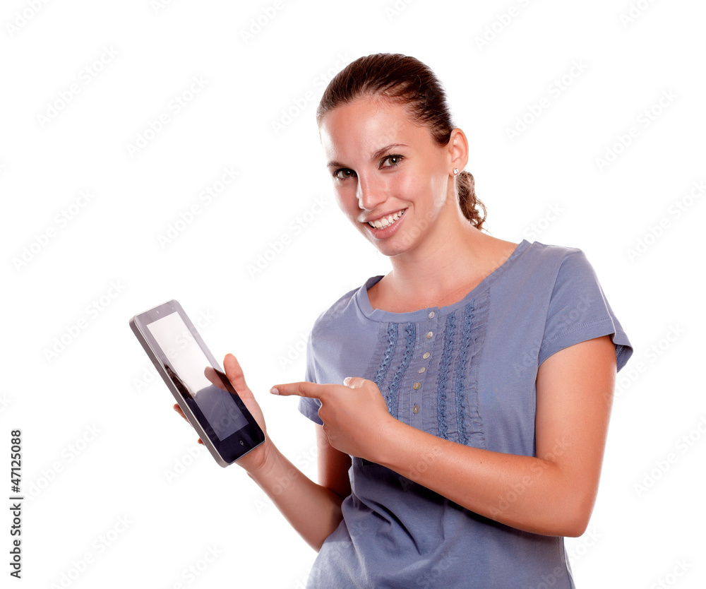Stylish young woman pointing tablet pc screen Stylish young woman pointing tablet pc screen