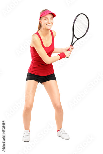 Full length portrait of female tennis player holding a racket