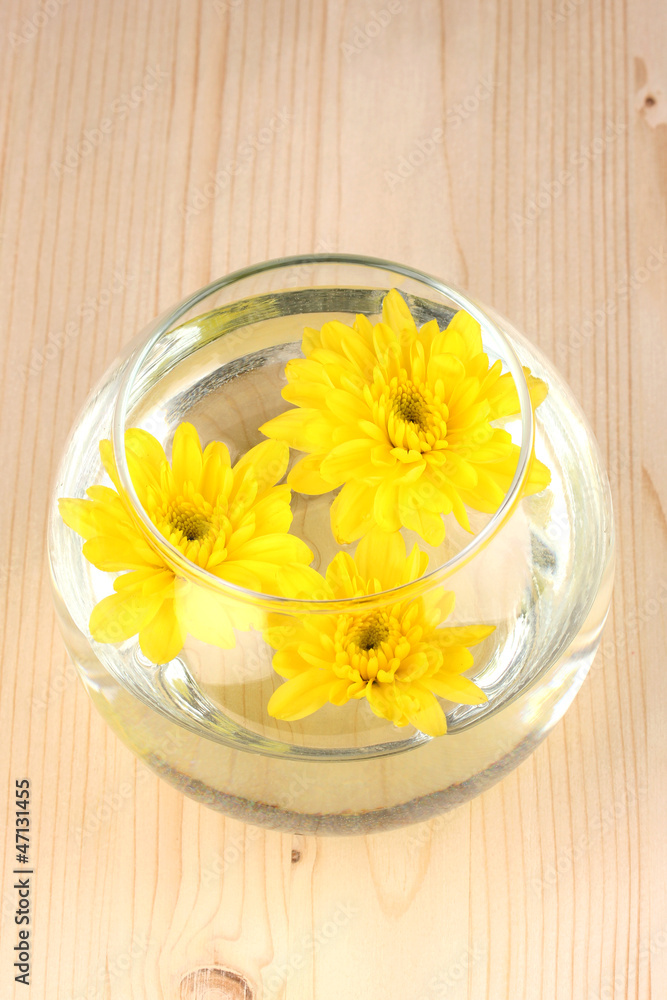 Vase with yellow flowers on wooden background Vase with yellow flowers on wooden background