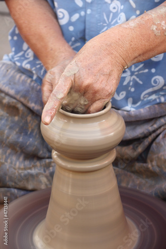 Old female hands making the traditional pottery