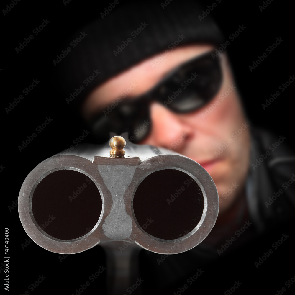 Gangster with shotgun aimed at you. Gun control concept. Stock-Foto | Adobe  Stock