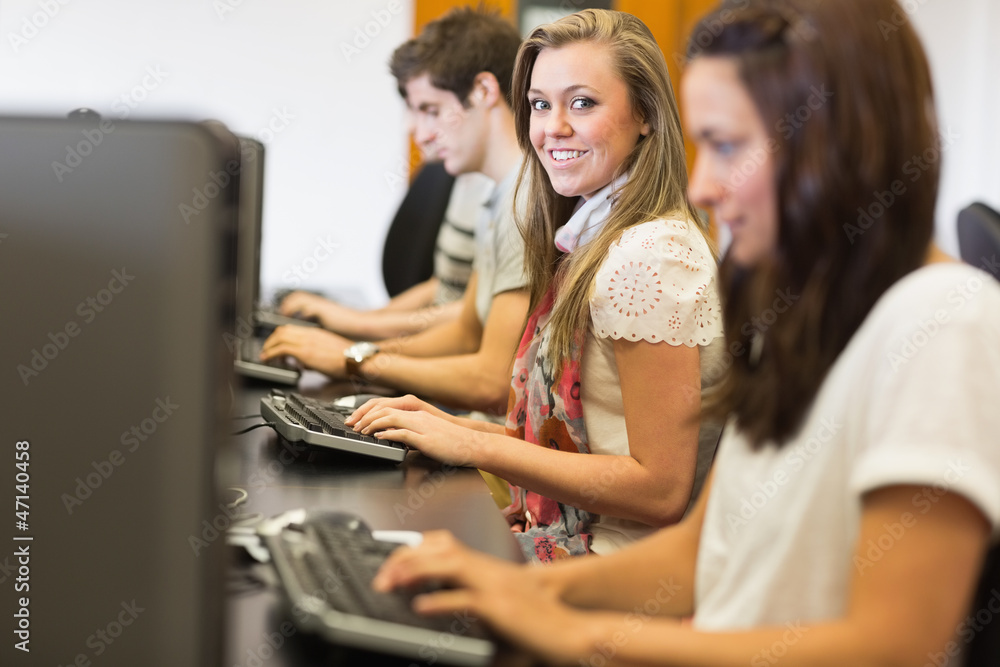 Students sitting at the computer smiling