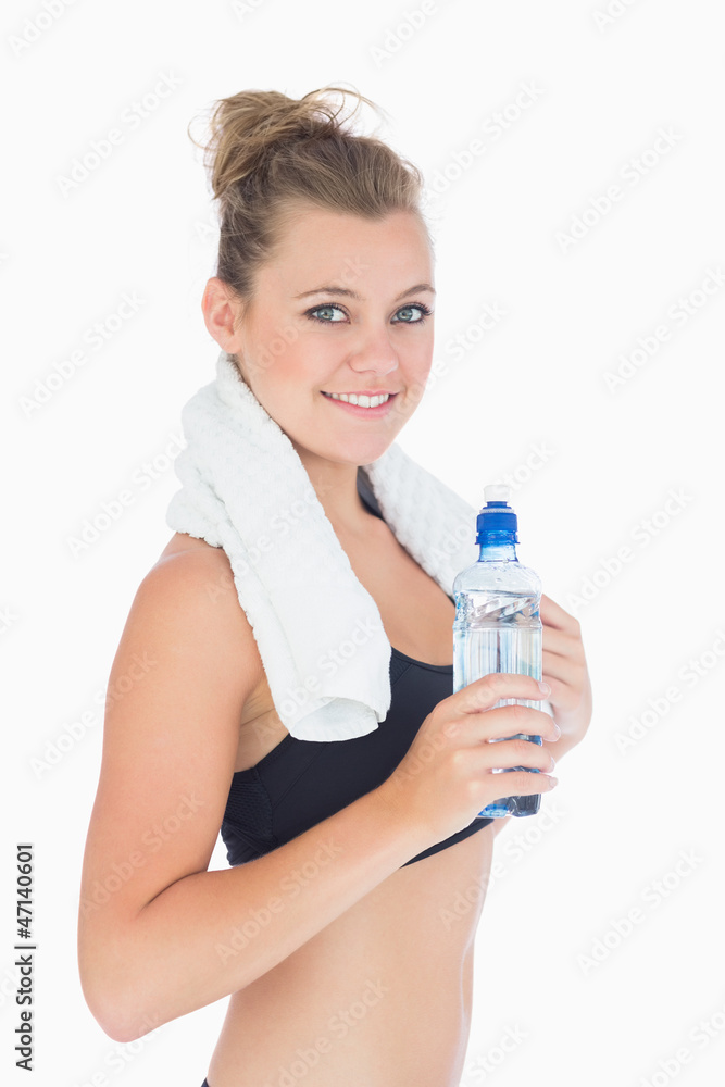 Woman smiling while holding a bottle Woman smiling while holding a bottle