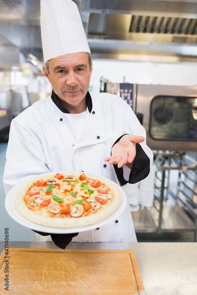 Cook presenting his pizza Cook presenting his pizza