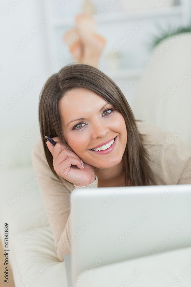 smiling woman using her laptop smiling woman using her laptop