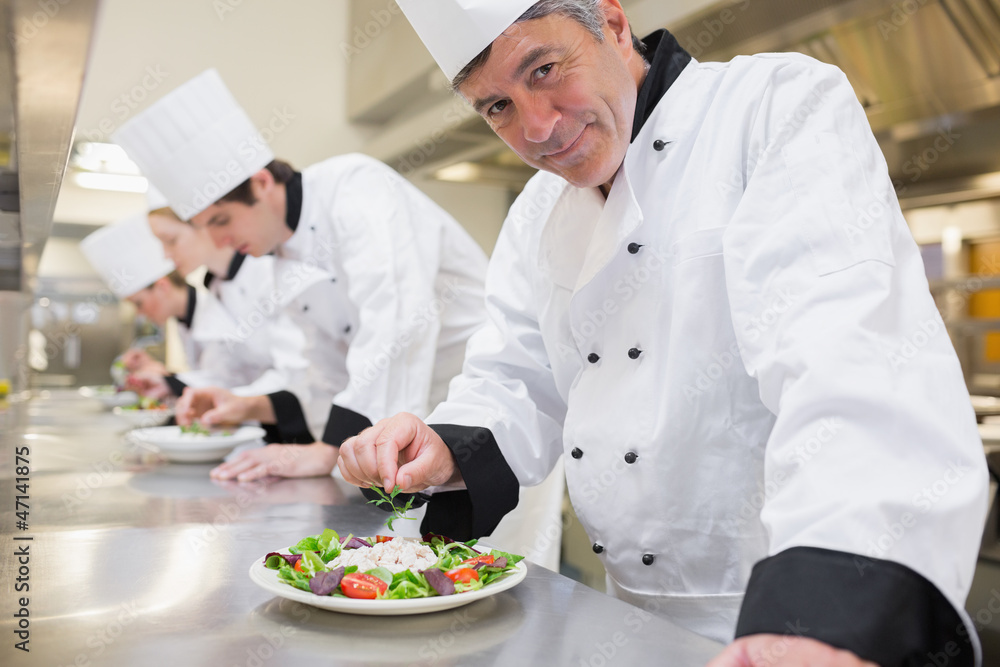 Smiling Chef's preparing their salads