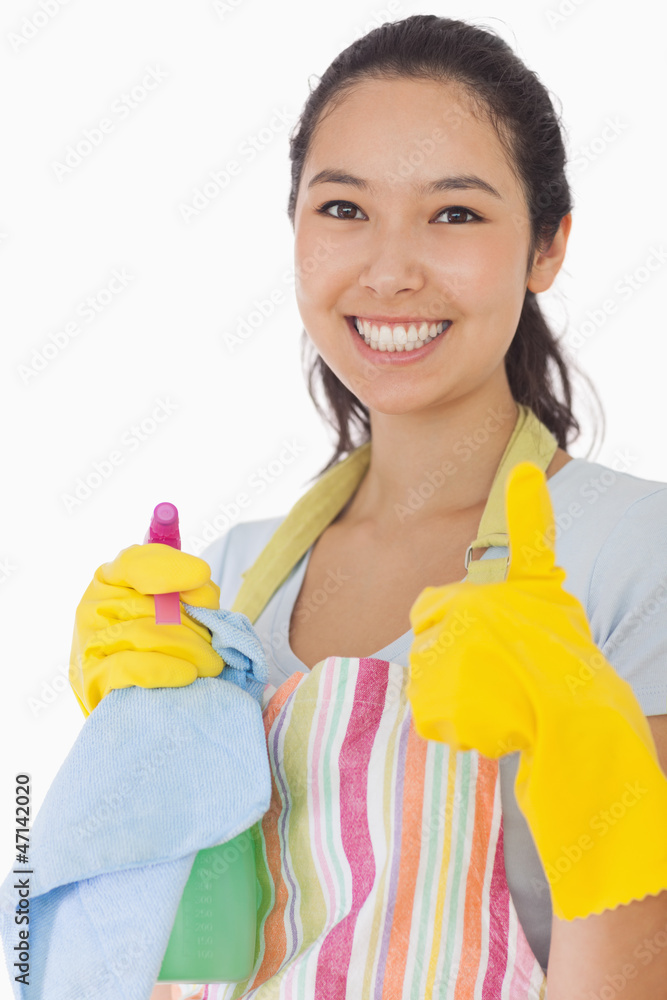 Smiling woman with cleaning products giving thumbs up Smiling woman with cleaning products giving thumbs up