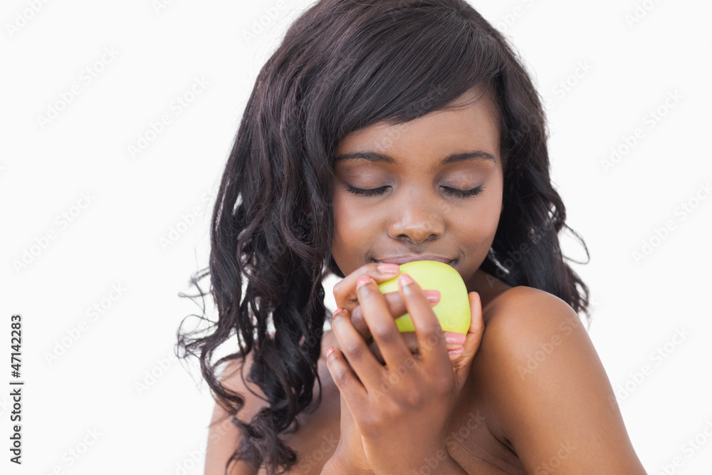 Woman holding an apple with eyes closed Woman holding an apple with eyes closed