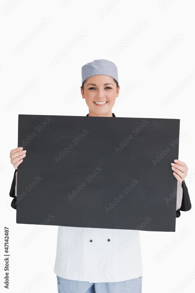 Smiling chef holding blackboard Smiling chef holding blackboard