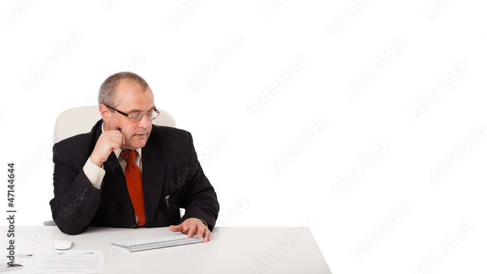 Businessman sitting at desk with copy space Businessman sitting at desk with copy space