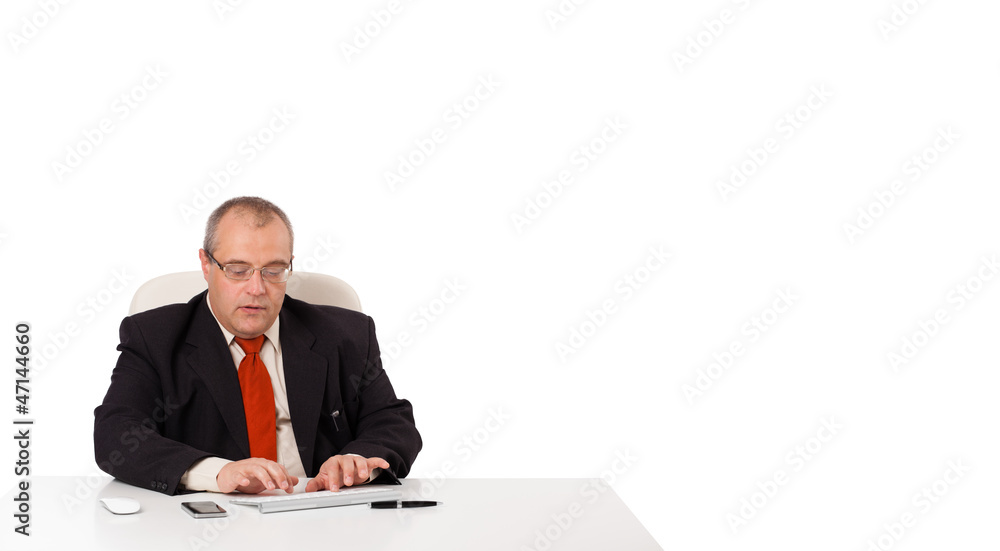 businessman sitting at desk and typing on keyboard with copy sca businessman sitting at desk and typing on keyboard with copy sca
