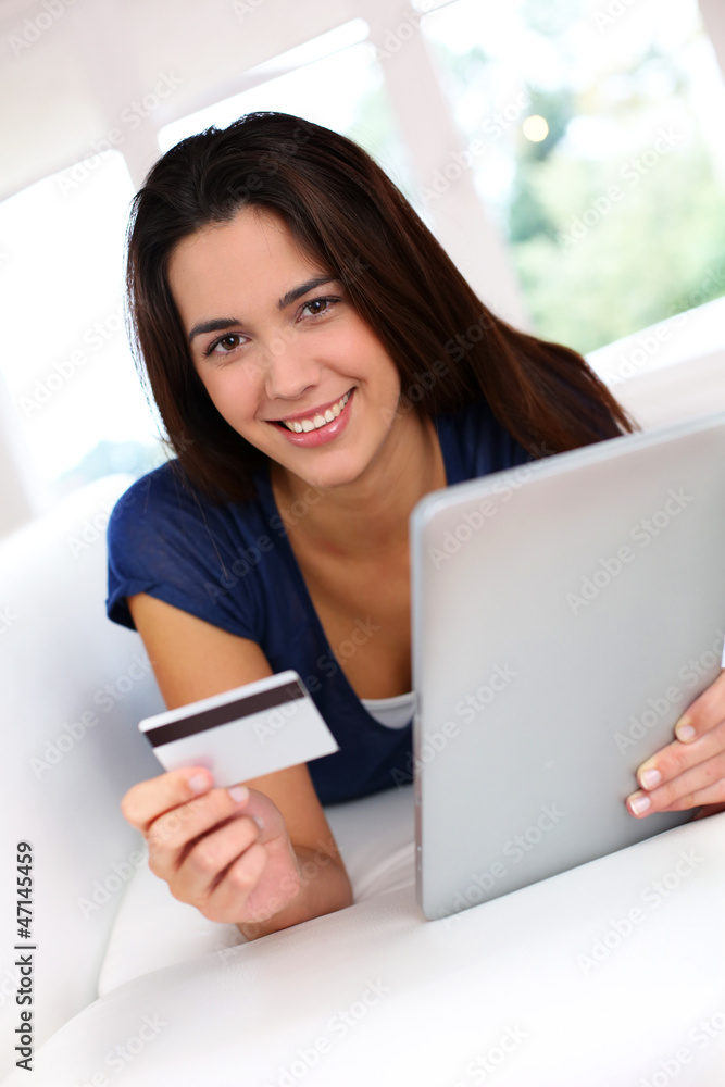 Brunette girl doing online shopping with digital tablet Brunette girl doing online shopping with digital tablet