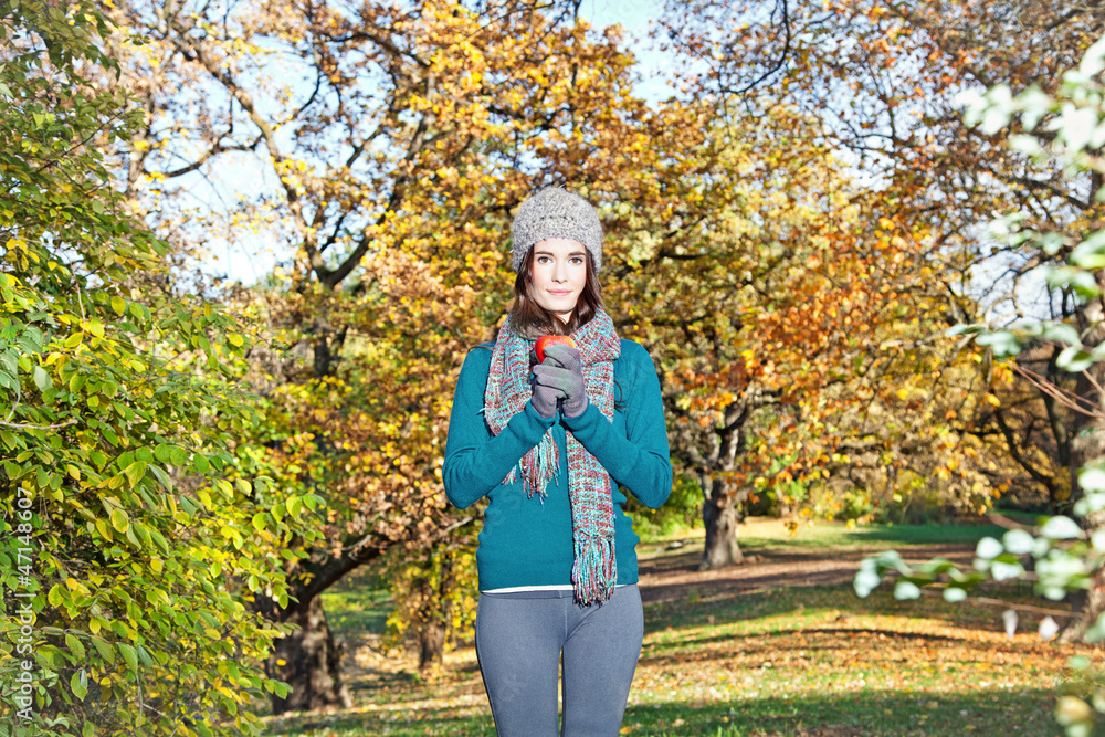 Beautiful girl hold an apple on sunny autumn-day Beautiful girl hold an apple on sunny autumn-day