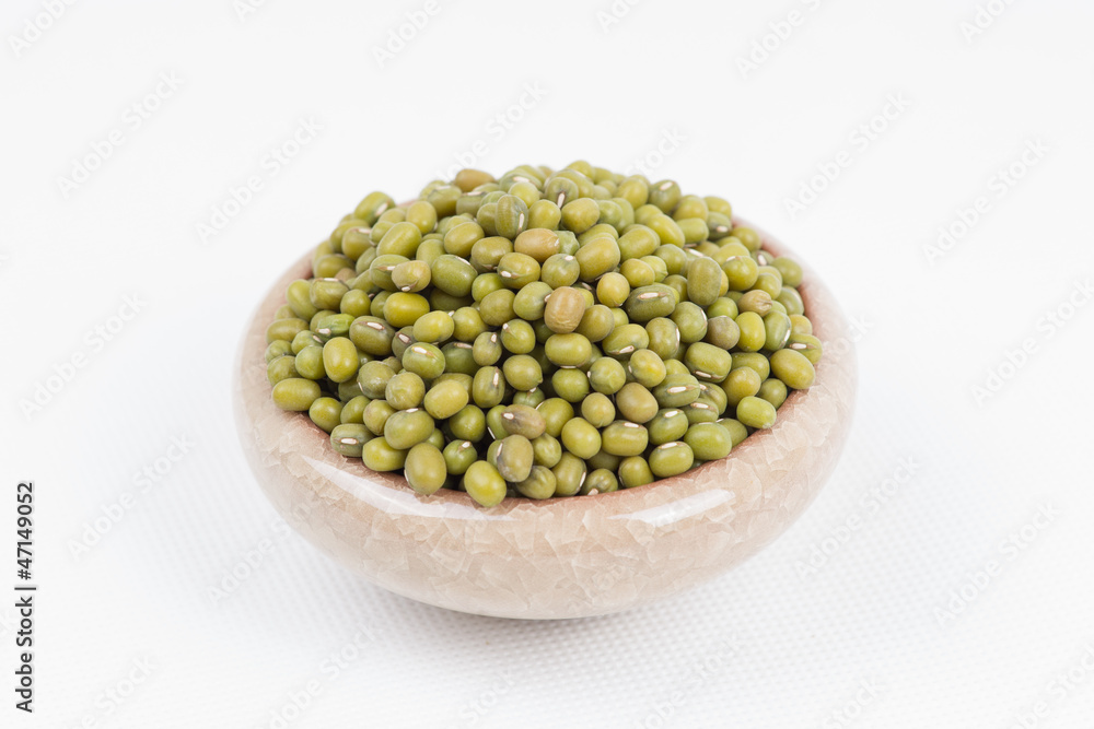 Green mung beans in bowl on white background Green mung beans in bowl on white background