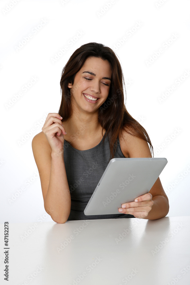 Smiling brunette girl websurfing with digital tablet Smiling brunette girl websurfing with digital tablet