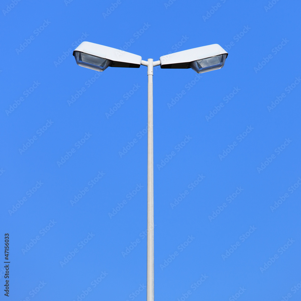 Double street lamp post on blue sky background Double street lamp post on blue sky background