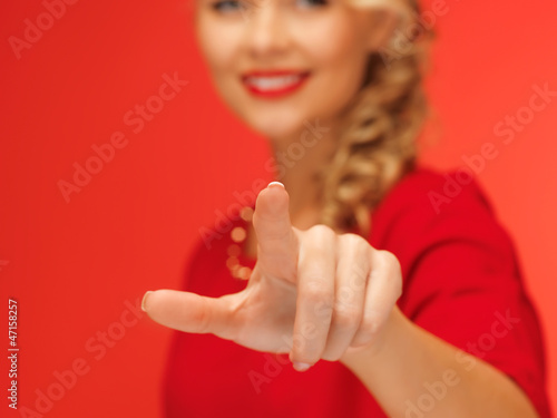 woman in red dress pressing virtual button photo